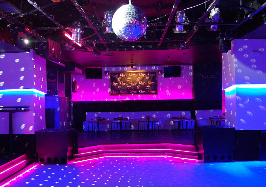Vibrant Nightclub Interior with Neon Lighting, Disco Ball, and Dance Floor HD wallpaper