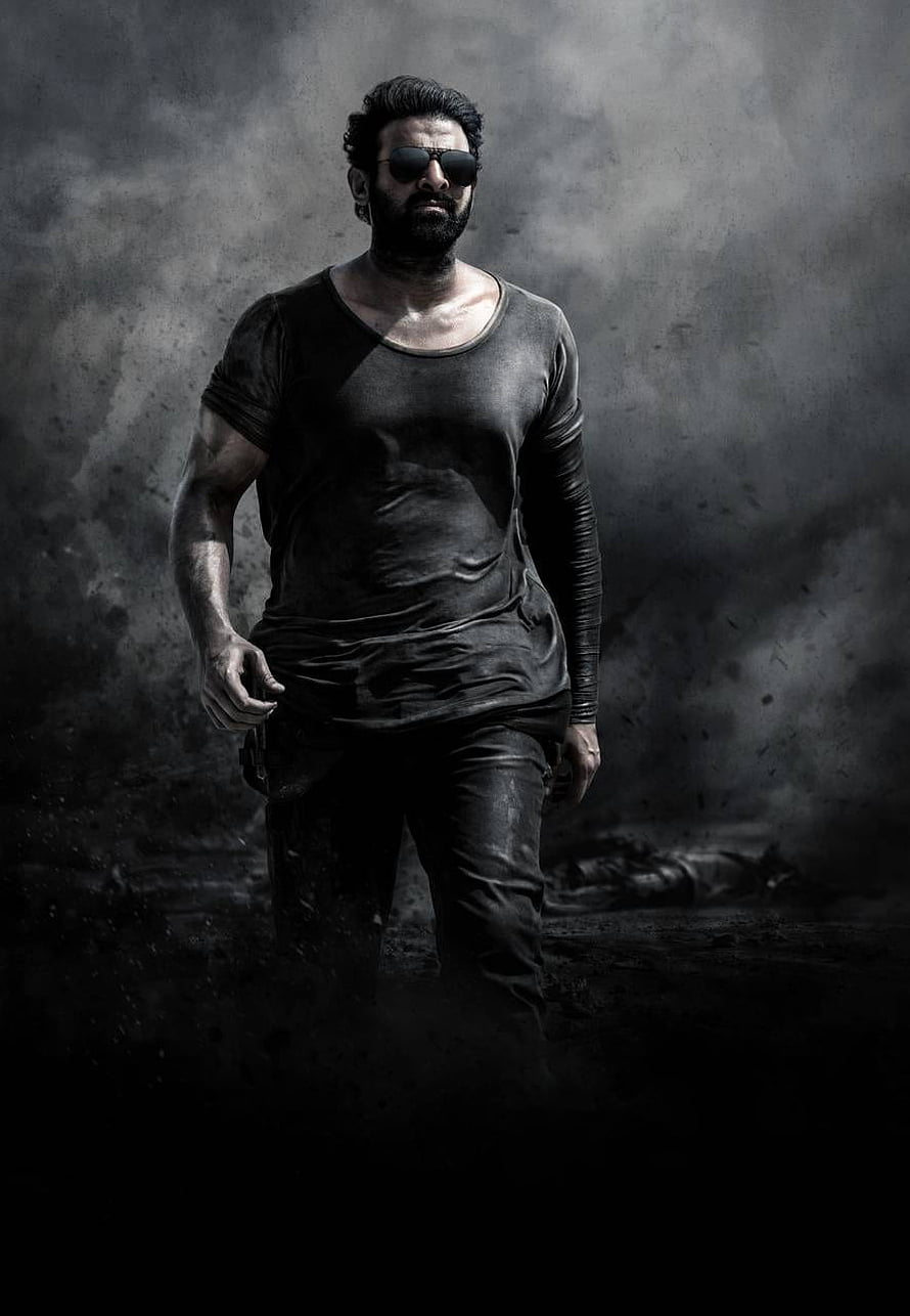 Prabhas as Salaar in a gritty monochrome action portrait with dark smoky atmosphere HD phone wallpaper