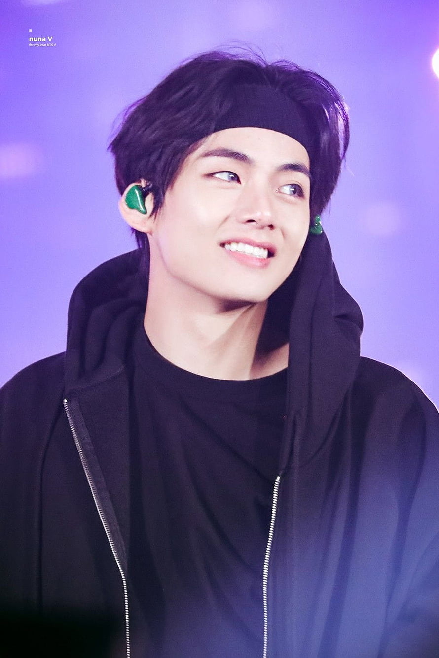 Kim Taehyung BTS V smiling in black hoodie with green in-ear monitors on stage HD phone wallpaper