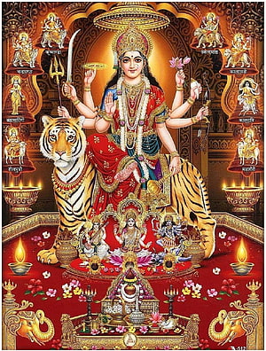 Navdurga and Maa Vaishno Devi seated on a tiger with oil lamps and floral offerings HD phone wallpaper