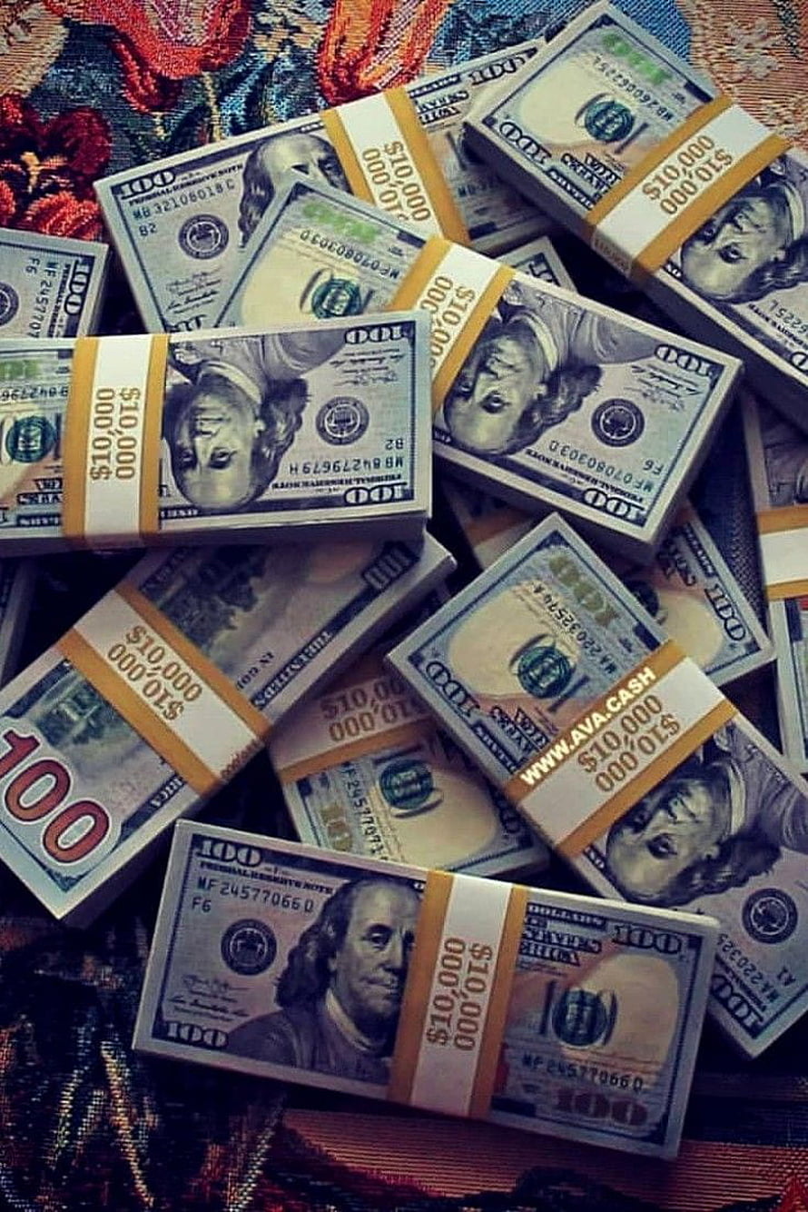 Stacks of One Hundred Dollar Bills on a Colorful Patterned Fabric HD phone wallpaper