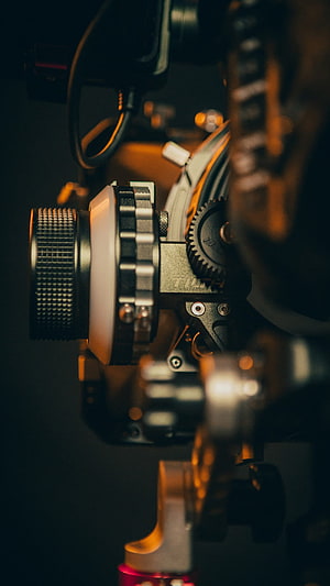 Cinematic Close-Up of Professional Film Camera Lens and Gears HD phone wallpaper
