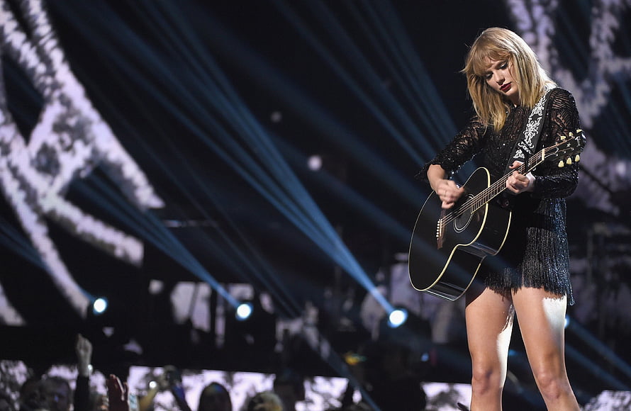 Taylor Swift performing with acoustic guitar on stage at the MTV Video Music Awards HD wallpaper