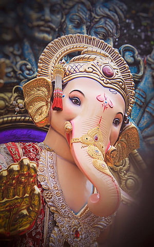 Chintamani Ganpati ornate golden deity portrait with intricate jewelry and traditional Indian artistry HD phone wallpaper