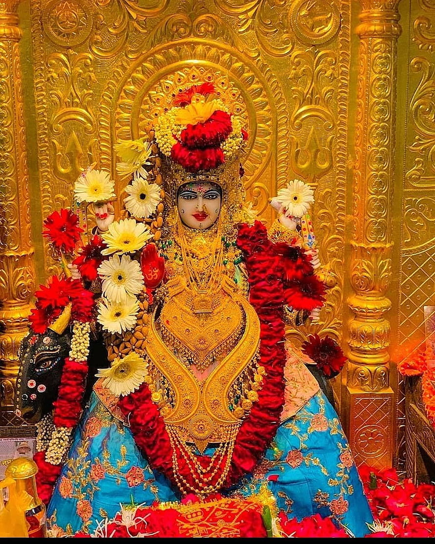 Meldi Maa Malataj Temple Idol Adorned in Gold Jewelry and Vibrant Flower Garlands HD phone wallpaper