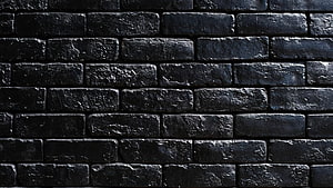 Dark Textured Black Brick Wall Pattern with Rough Surface and Industrial Aesthetic HD wallpaper