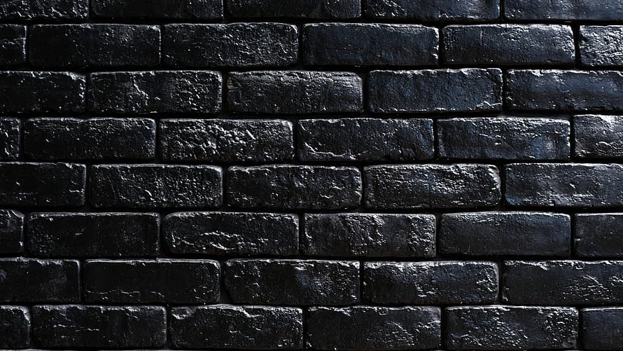 Dark Textured Black Brick Wall Pattern with Rough Surface and Industrial Aesthetic HD wallpaper