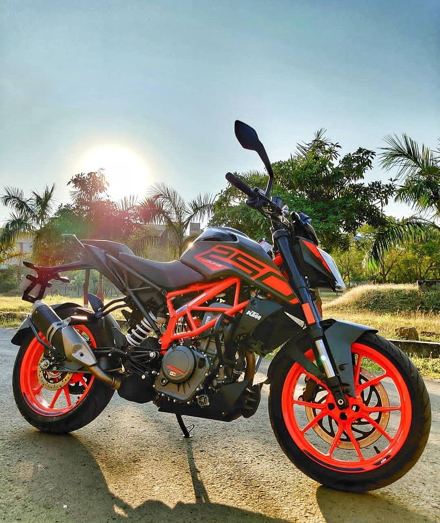 KTM Duke 250 Black and Orange Naked Motorcycle Parked on a Tropical Road at Sunset HD phone wallpaper