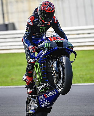 Fabio Quartararo on Yamaha YZR-M1 performing a wheelie at the 2021 MotoGP World Championship HD phone wallpaper
