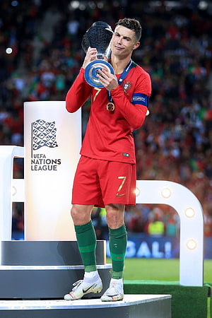 Cristiano Ronaldo lifting the UEFA Nations League trophy in Portugal red kit HD phone wallpaper