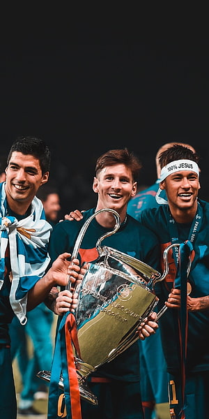 Lionel Messi and Luis Suarez celebrate with the UEFA Champions League trophy HD phone wallpaper