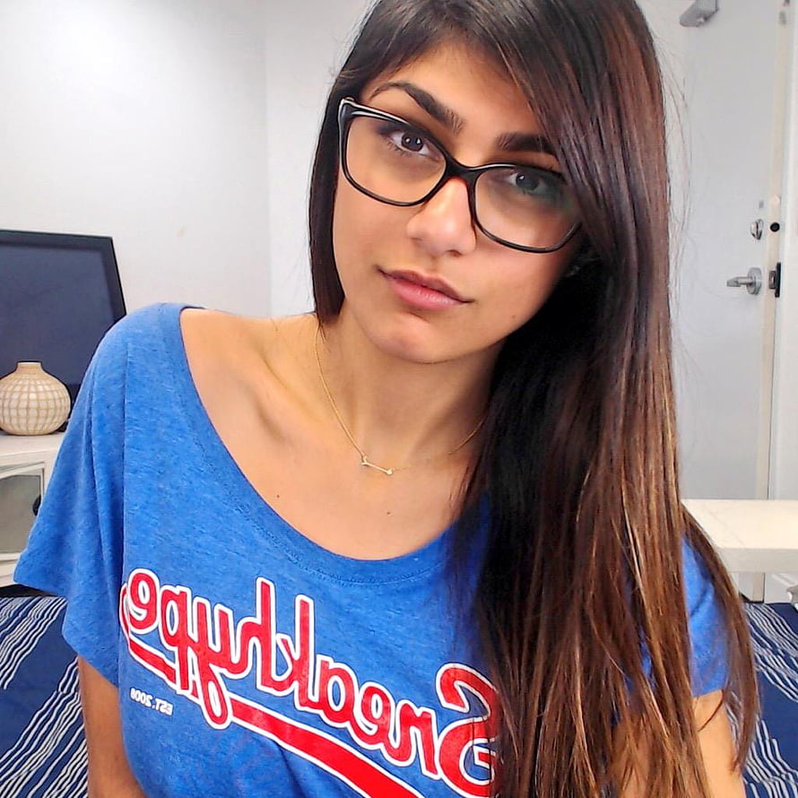 Mia Khalifa Wearing Black Glasses and a Blue Graphic T-Shirt in a Casual Indoor Portrait HD phone wallpaper