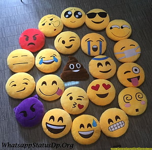 Collection of Emoji Plush Toys Arranged in a Circle on a Wooden Floor HD wallpaper