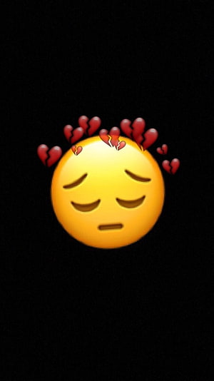 Yellow Sad Emoji with Broken Hearts on Black Background HD phone wallpaper