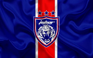 Johor Darul Ta'zim FC Crest on Flowing Blue Silk Fabric with Red and White Vertical Stripe HD wallpaper