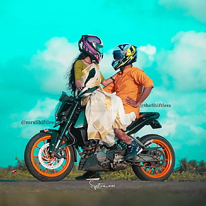 Couple Riding a Green Motorcycle with Orange Rims Under a Turquoise Sky HD phone wallpaper