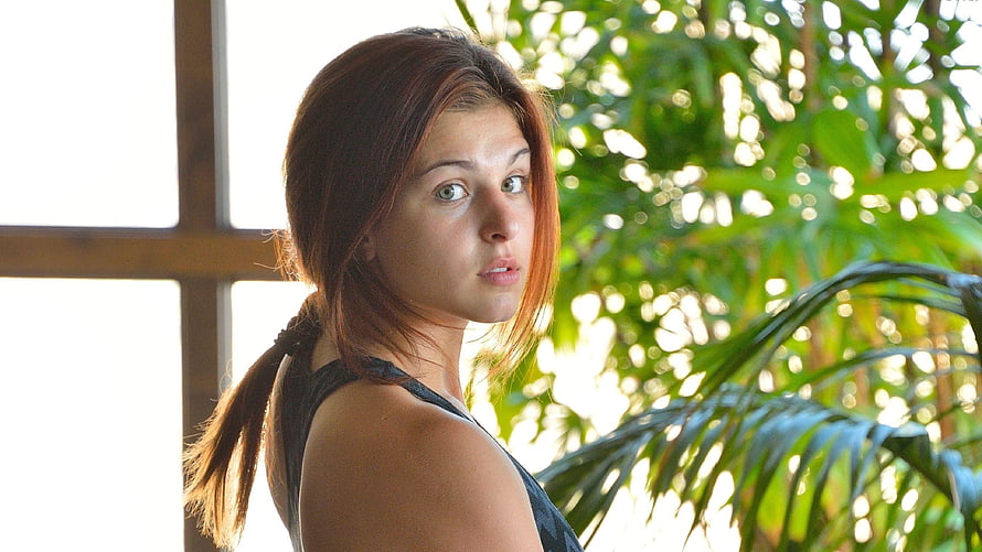 Leah Gotti Portrait in Tropical Setting with Lush Green Foliage and Natural Light HD wallpaper