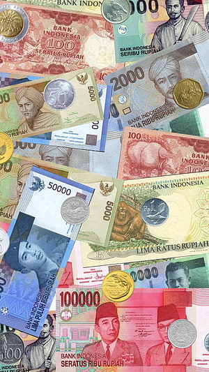 Assorted Indonesian Rupiah Banknotes and Coins Displayed in a Colorful Overlapping Arrangement HD phone wallpaper