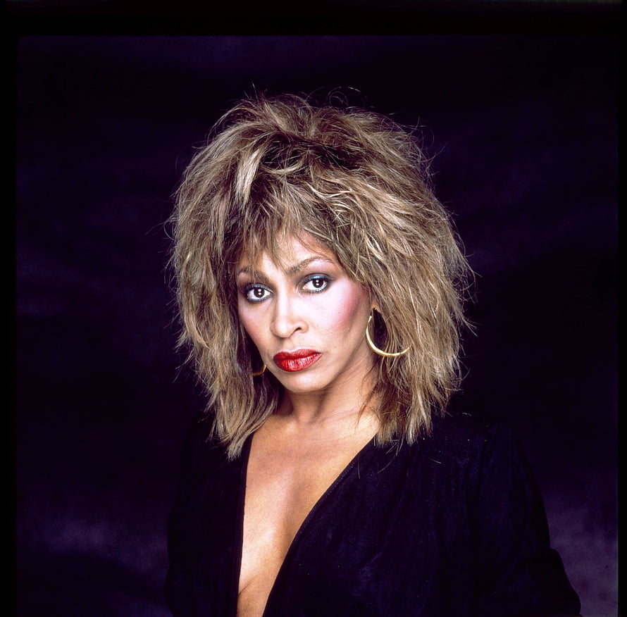 Tina Turner Studio Portrait with Voluminous Hair and Gold Hoop Earrings HD wallpaper