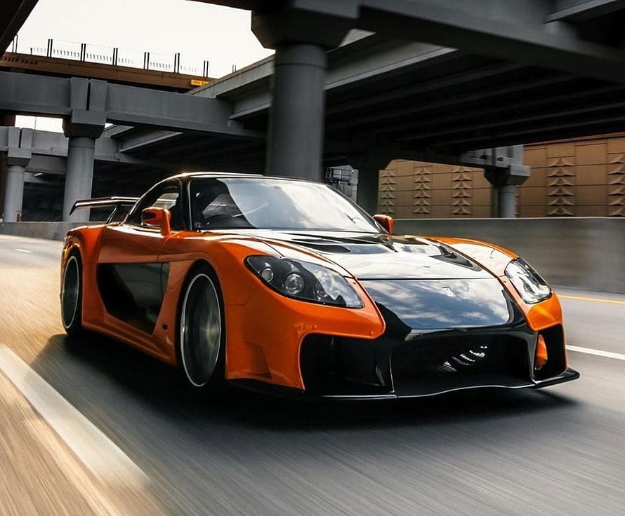 Veilside Mazda RX-7 Supercharged Widebody Coupe in Orange and Black on Urban Highway HD wallpaper