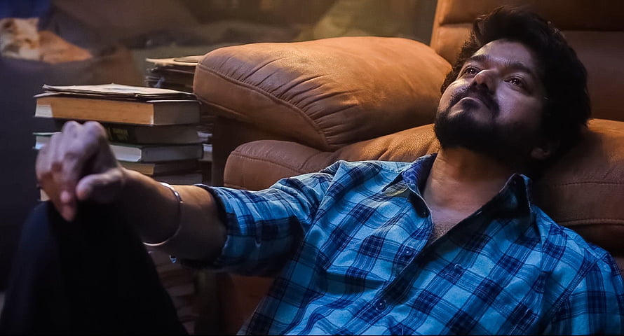 Vijay Sethupathi Reclining in Leather Armchair with Stacked Books HD wallpaper