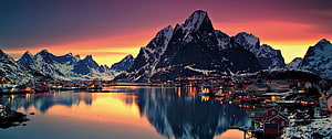 Reine Village in Lofoten Islands at Winter Sunset with Snowy Peaks and Fjord Reflections HD wallpaper