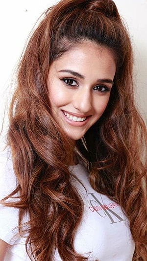 Disha Patani smiling portrait with long wavy auburn hair and white t-shirt HD phone wallpaper