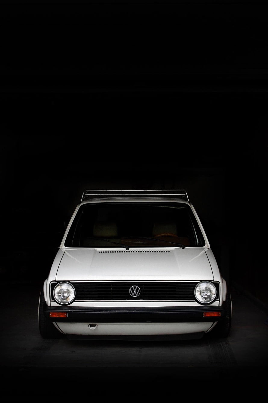 Classic White Volkswagen Golf Mk1 Front View Against Dark Studio Background HD phone wallpaper
