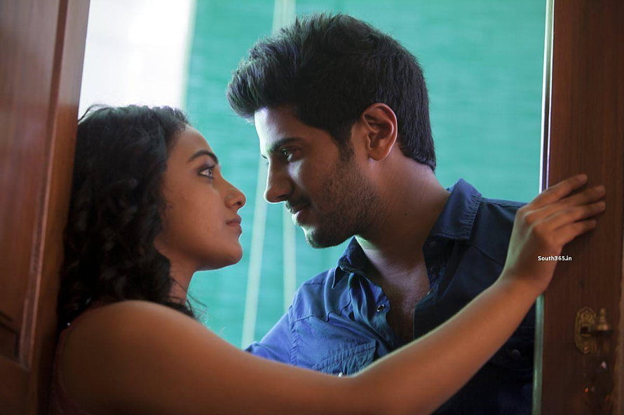 Dulquer Salmaan and Nithya Menon in an intimate doorway scene from the Tamil film O Kadhal Kanmani HD wallpaper