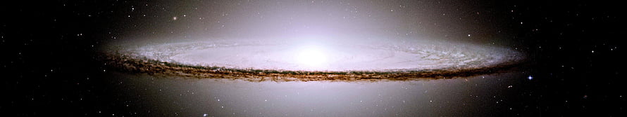 Edge-On Spiral Galaxy with Bright Core and Dust Lanes in Deep Space HD wallpaper