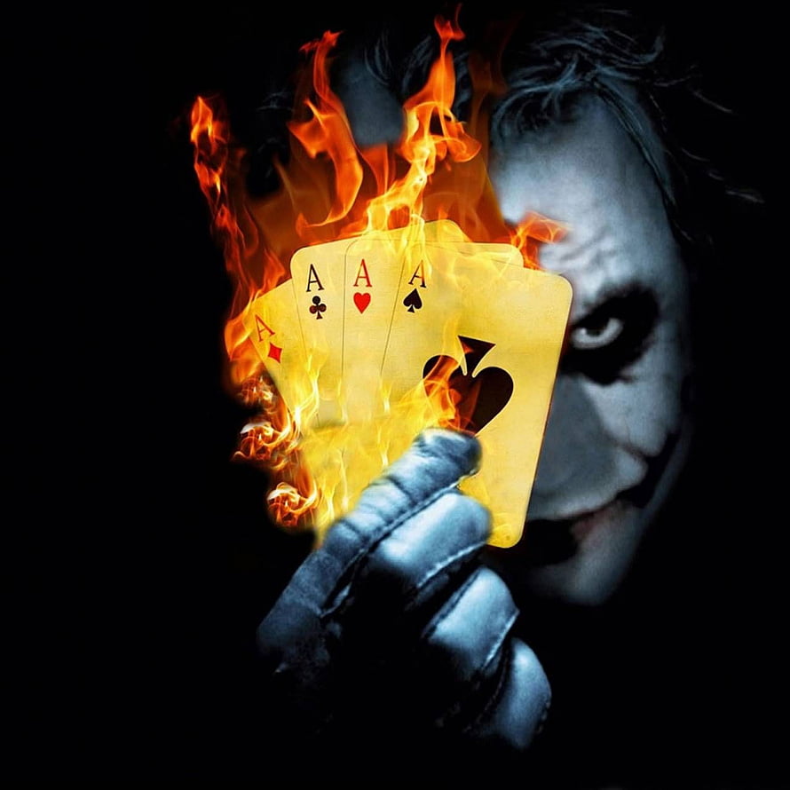 Joker Holding Burning Ace Playing Cards in Dark Cinematic Style HD phone wallpaper