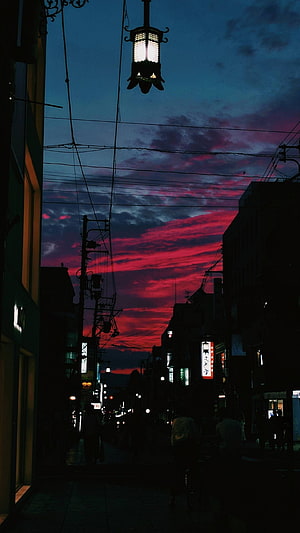 Vivid Crimson Sunset Over Nara Japan Street with Silhouetted Lantern and Power Lines HD phone wallpaper