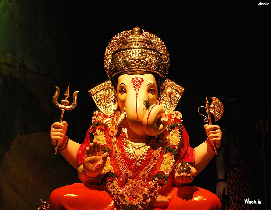 Ornate Lord Ganesha Statue Adorned in Red Garments and Gold Jewelry Against a Dark Backdrop HD wallpaper