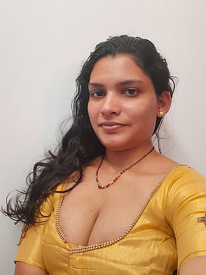 Resmi R Nair in a golden blouse with beaded neckline and traditional necklace HD phone wallpaper