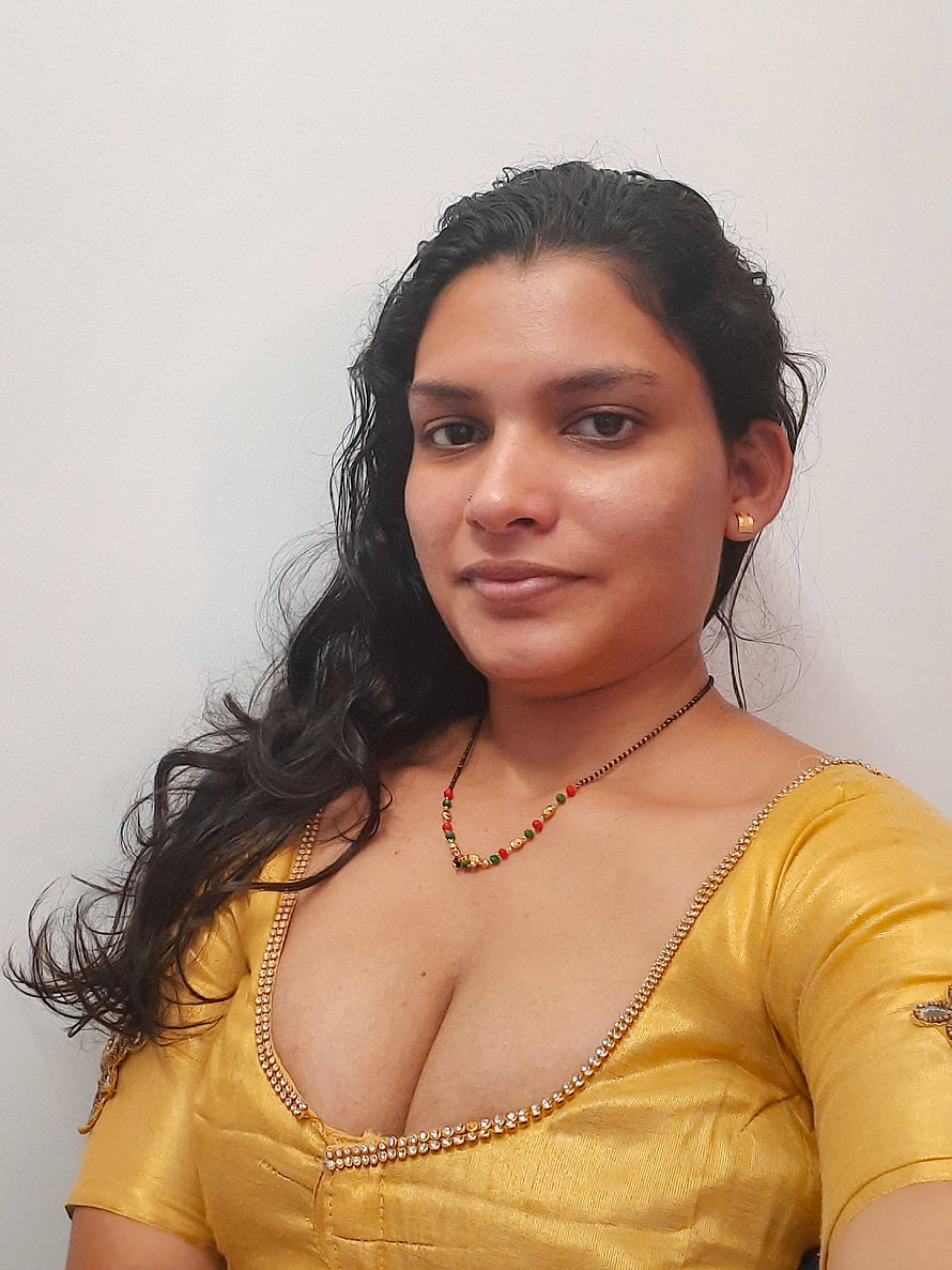 Resmi R Nair in a golden blouse with beaded neckline and traditional necklace HD phone wallpaper
