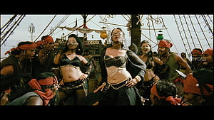 Anushka Shetty in a dramatic pirate ship dance scene with crew members HD wallpaper