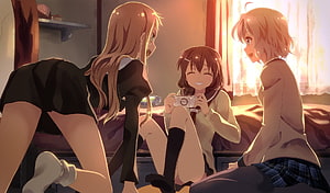 Three anime girls in school uniforms sharing a cozy moment with a handheld console in warm sunlight HD wallpaper
