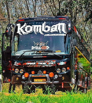 Komban Holiday Coach with Custom Graphics and Front View in a Forest Setting HD phone wallpaper