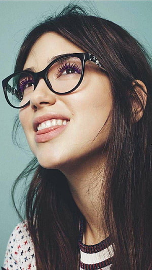 Dua Lipa smiling portrait wearing black cat-eye glasses with long dark hair HD phone wallpaper