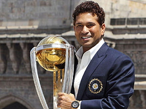 Sachin Tendulkar holding the ICC Cricket World Cup trophy in a navy blue blazer HD wallpaper
