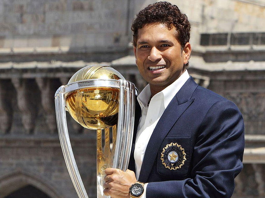Sachin Tendulkar holding the ICC Cricket World Cup trophy in a navy blue blazer HD wallpaper