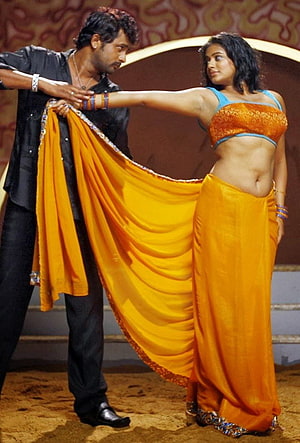 Priyamani in Vibrant Orange Saree Performing Traditional Dance on Stage HD phone wallpaper