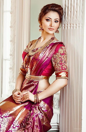 Urvashi Rautela in a richly embroidered magenta and gold silk saree with traditional jewelry HD phone wallpaper