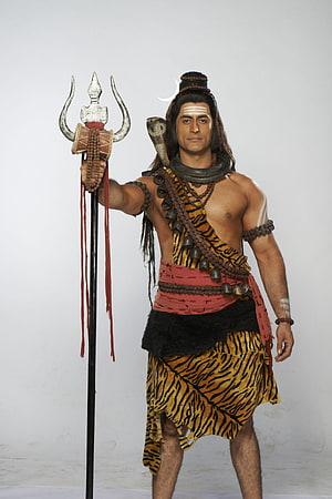 Mahadev Character Portrait in Tiger Skin and Rudraksha Beads Holding Trident HD phone wallpaper