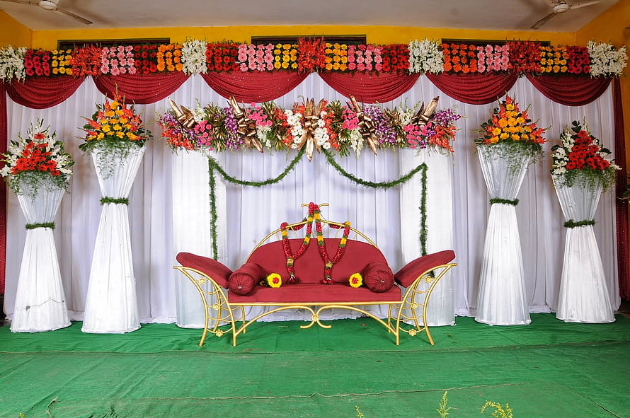 Traditional Indian Wedding Stage Decor With Floral Pillars And Red Sofa HD wallpaper