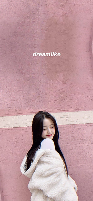 Jang Wonyoung in a cream fleece jacket against a soft pink wall with a dreamlike aesthetic HD phone wallpaper