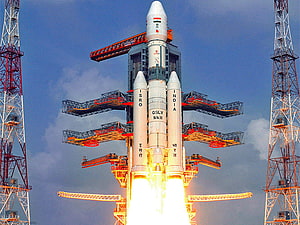 ISRO GSLV Mk III rocket launch with bright engine exhaust and launch tower HD wallpaper