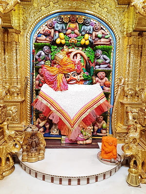 Hanuman Temple Shrine with Golden Carvings and Devotional Offerings HD phone wallpaper