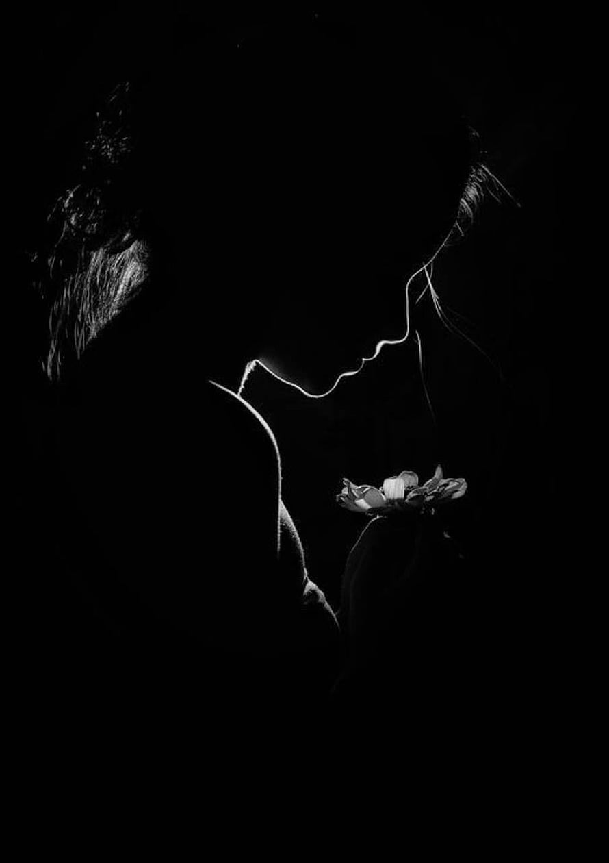 Monochromatic Silhouette of a Woman Holding a Flower in Dramatic Low-Key Lighting HD phone wallpaper