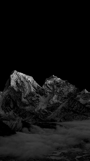 Dramatic Black and White Mountain Peaks Rising Above a Sea of Clouds HD phone wallpaper